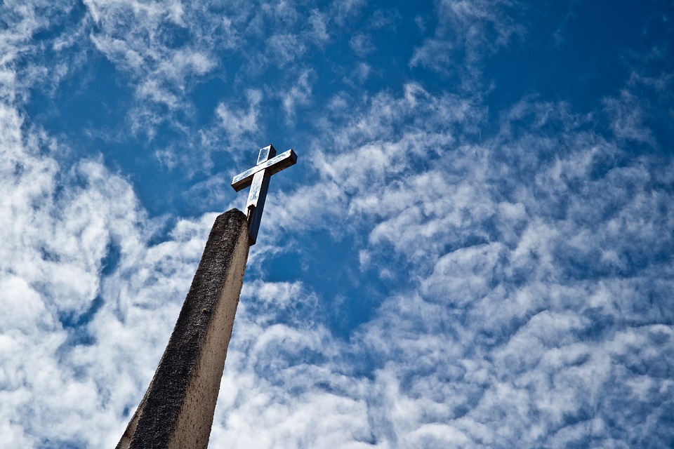 A picture of a cross on a stone column