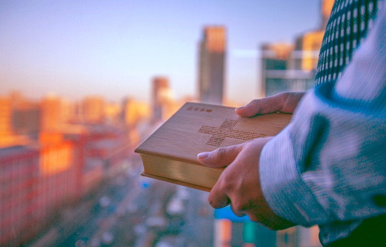 A picture of a man holding the Bible
