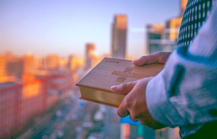 A picture of a man holding the Bible
