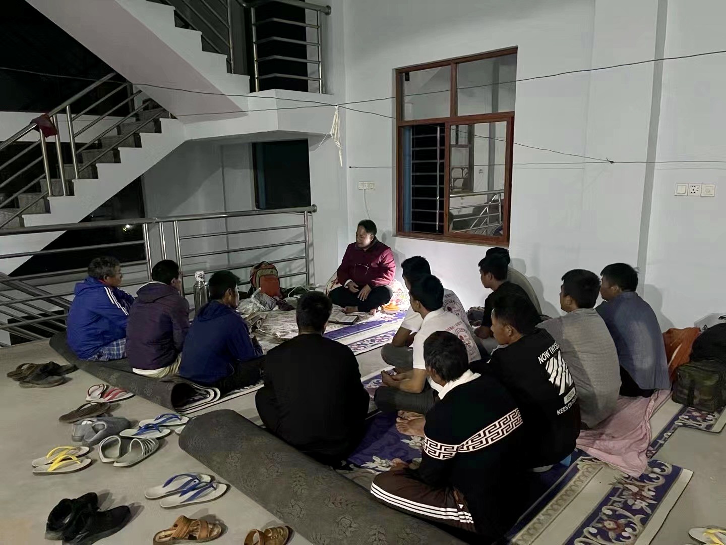A group photo was taken during the Bible study at a public housing of the village in Muse City, Myanmar, during refuge since December 2, 2023.