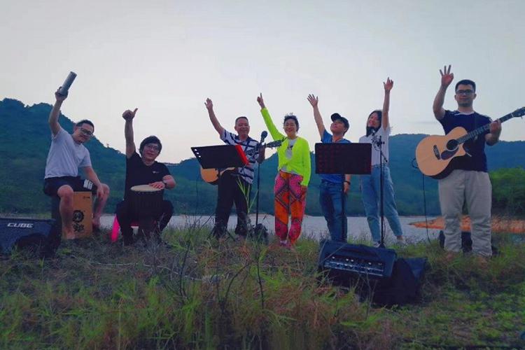 A picture of a group of young men worshipping God in the wild