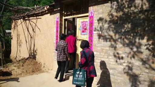 A picture of several believers attending service in a rural village