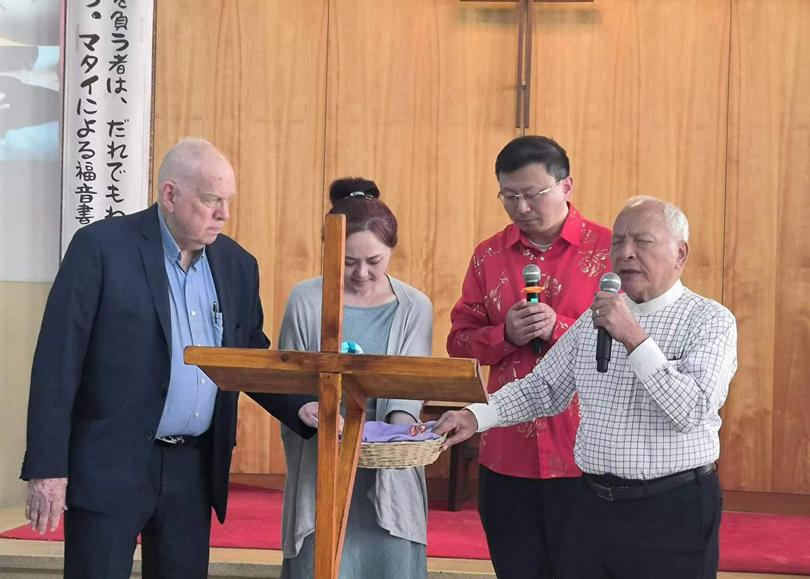 Pastor Shenzhu Zhou prayed with other Christians during “the Revival Conference for Moses-Joshua Walking Together as Two Generations” held in Kobe, Japan, on May 4, 2024.