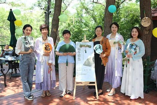 Female members took a group picture with fans featuring the Dragon Boat Festival at Jiangsu Road Church in Qingdao, Shandong, on June 10, 2024.