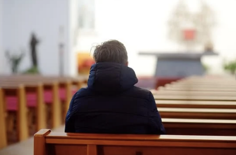 A man sits in a church.