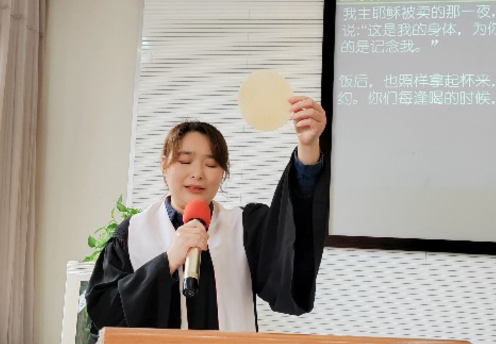 A woman pastor consecrated the bread during a footwashing and communion service at Shishan Church, Suzhou, Jiangsu, on Maundy Thursday, March 28, 2024.