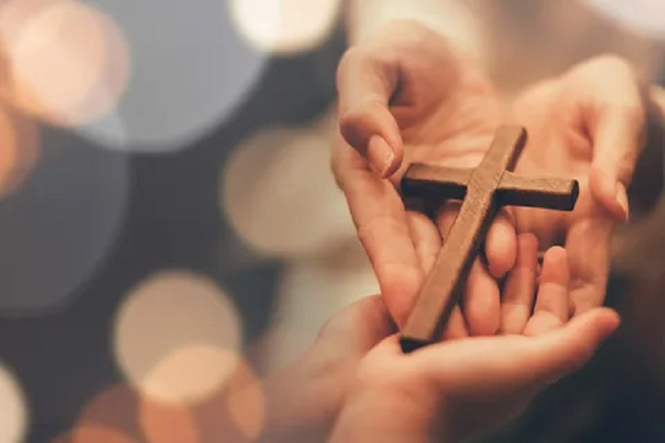 A picture of a person passing a cross to another one