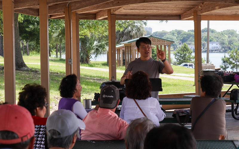 Pastor Hand Pyo Kim delivered God's Word during an outdoor worship session on an unspecified day.