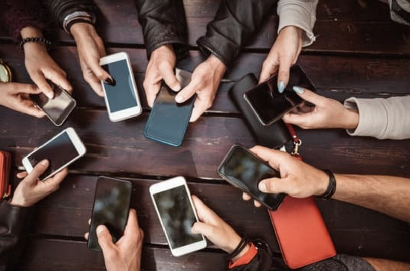 A picture of hands holding smartphones