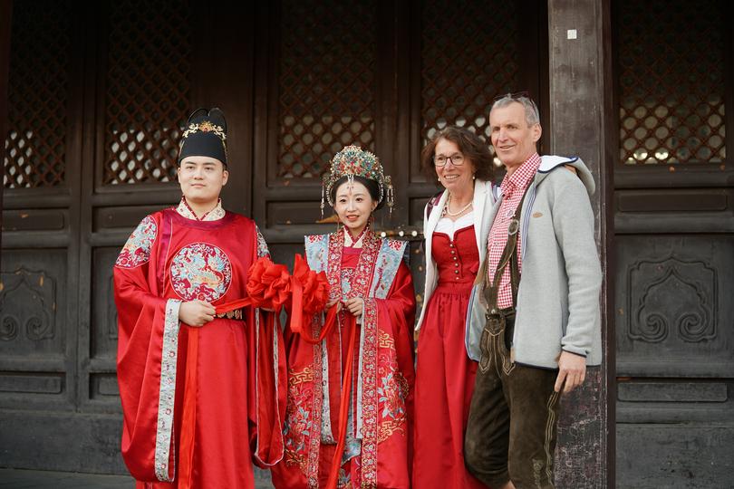 Two members of YMCA Bavaria, Germany took a photo with a Chinese couple on an unknown day during their recent March trip to China. 
