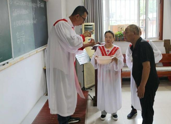 Assistant Pastor Wang Shengjun explains the meaning of baptism to a deaf seeker on an unknown day.