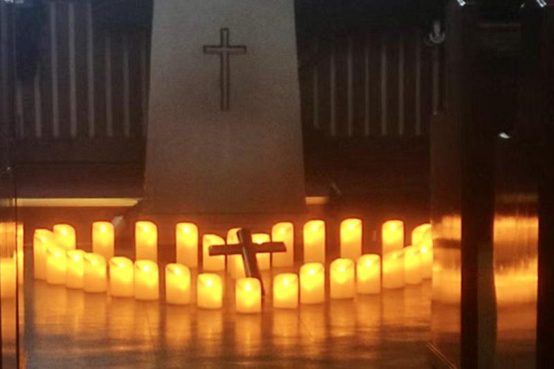 A cross lay among electronic candles arranged in a heart-shaped circle during a Taizé prayer service at Wuxi International Church in Wuxi, Jiangsu Province, on April 16, 2025.