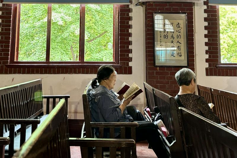 Elderly Christian women read the Bible on the pews at a church in central China on April, 17, 2025.