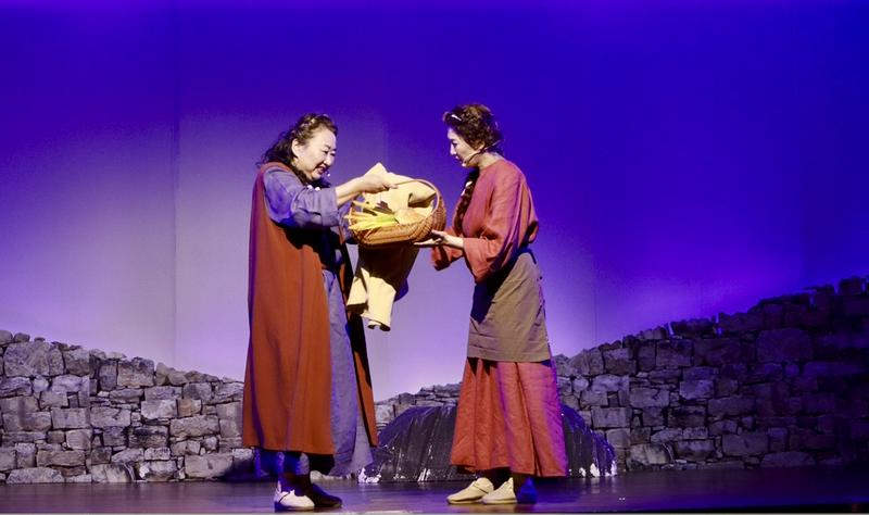 Two Christian women portrayed Naomi and Ruth, with Ruth offering gleaned grain to Naomi in a scene from the musical at Qiaocheng Church in Shenzhen, Guangdong Province, on May 10, 2025.