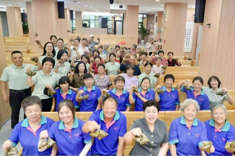 The Elderly Cloud Fellowship held zongzi in their hands to celebrate the Dragon Boat Festival at Longcheng Church, Longgang District, Shenzhen, on May 28, 2025.