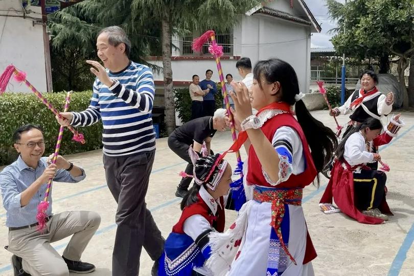 Board members from World Vision China joined in a traditional folk dance with the local children at a Bai ethnic village at the base of Yulong Snow Mountain in Yulong Naxi Autonomous County, Lijiang, in Yunnan provinceon June 17, 2025.