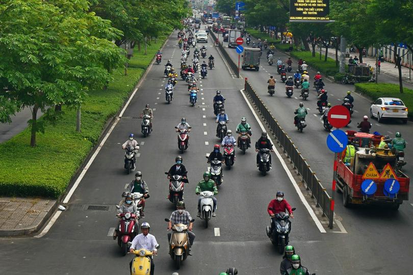 People rode motorcycles on a street on an unknown day.