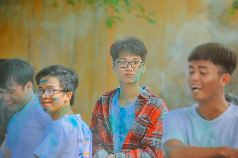 Four young man with paints standing
