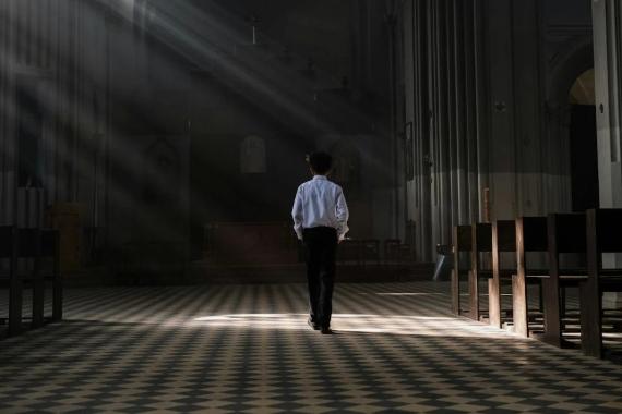A boy walked in a church on an unknown day.