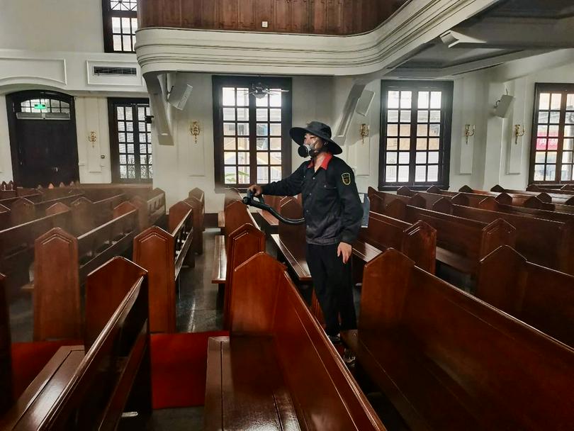 A woman conducted mosquito fogging treatment in Savior Church in Guangzhou, Guangdong, in July 2025.