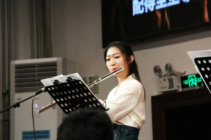 A Christian woman performed a flute during the thanksgiving and praise ceremony marking the Mid-Autumn Festival held at Gangwashi Church in Beijing on September 25, 2025.
