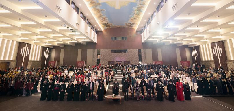 People pose for a photo at the conclusion of the closing session of the World Council of Churches Sixth World Conference on Faith and Order on October 28, 2025, in Wadi El Natrun, Egypt.