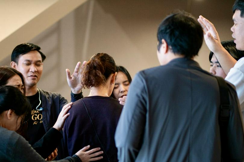 A group of people prayed together on an unknown day.