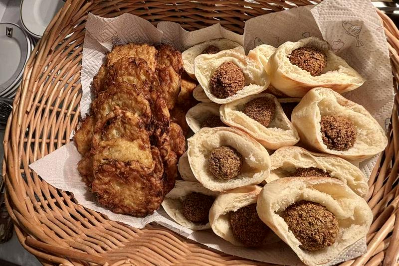 Traditional latkes (fried potato pancakes) and chickpea pitas offered at Ravit Baer's residence in Shanghai, on December 17, 2025