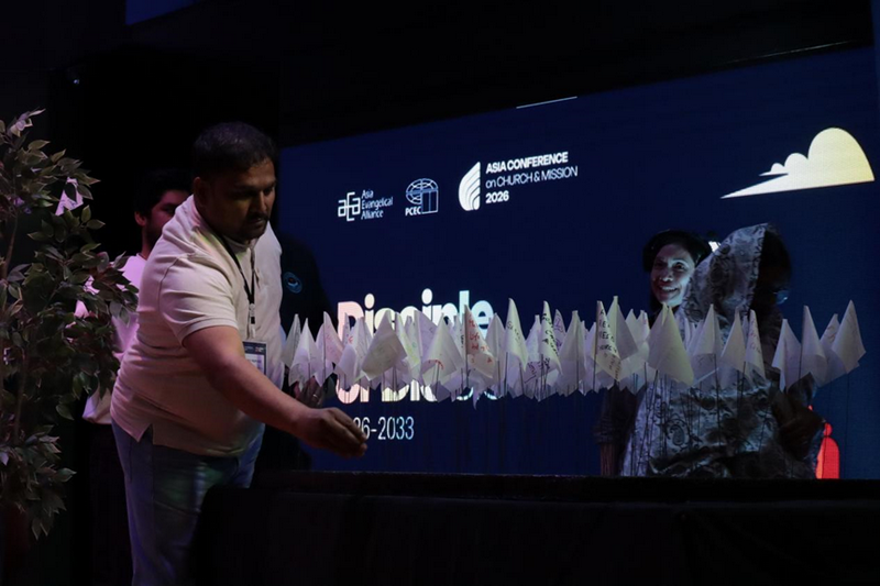 A participant received a small white flag and wrote on it the name of a church he hoped to see become a disciple-making church at the closing session of ACCM 2026 at GCF South Metro in Alabang, Metro Manila, June 11, 2026.