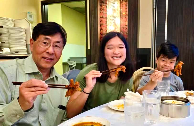 “Uncle Clyde” enjoying chicken feet with Torie and Daniel—a taste of China shared together.