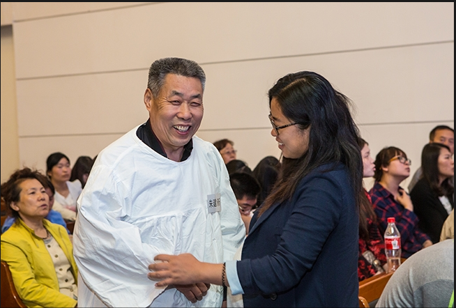 A pregant sister attends the baptism service of her father