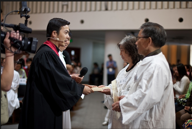 A senior couple receive the baptism both
