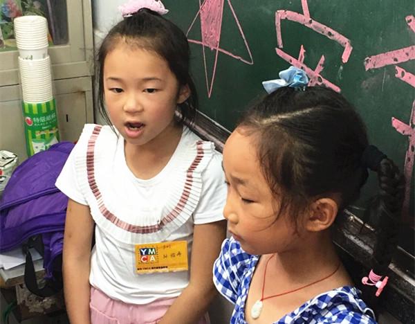 Volunteers are teaching the children to sing folk songs