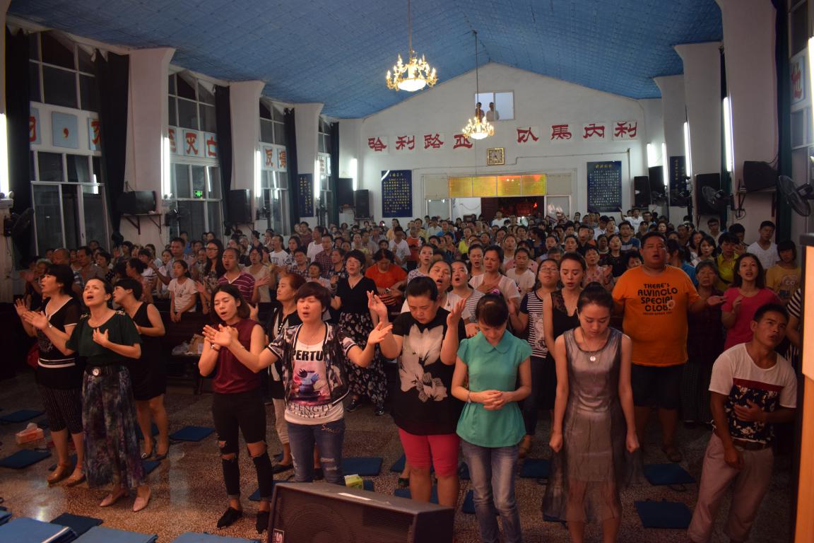 The congregation of a Chinese church prays together.
