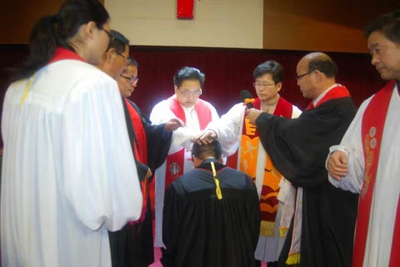 The ordination team ordains a co-worker