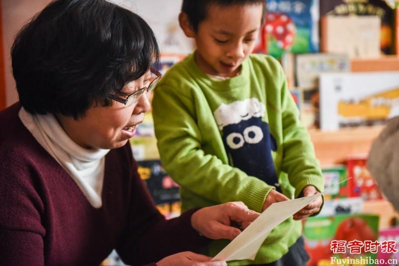 A teacher teaches a child in the orphanage
