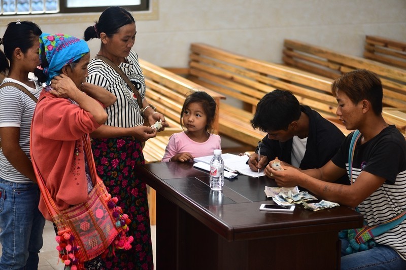 Believers are giving tithe in the church.