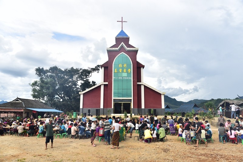 Christians eat together in the church yard.