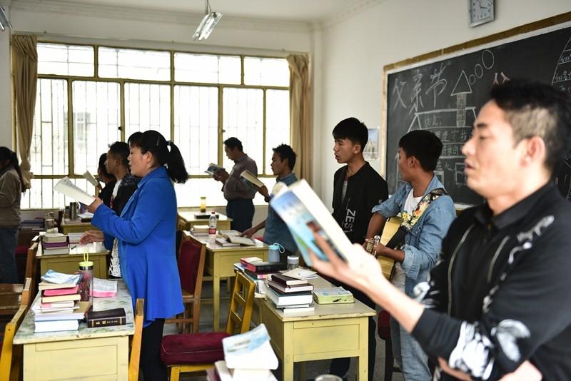 Some of the school's students sing hymns. 