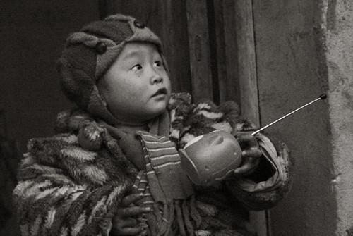 Gao Jun held a toy at his house door.