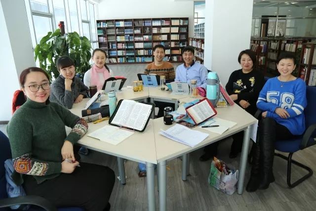 A group of students read the Bible in the library of Heilongjiang Theological Seminary.