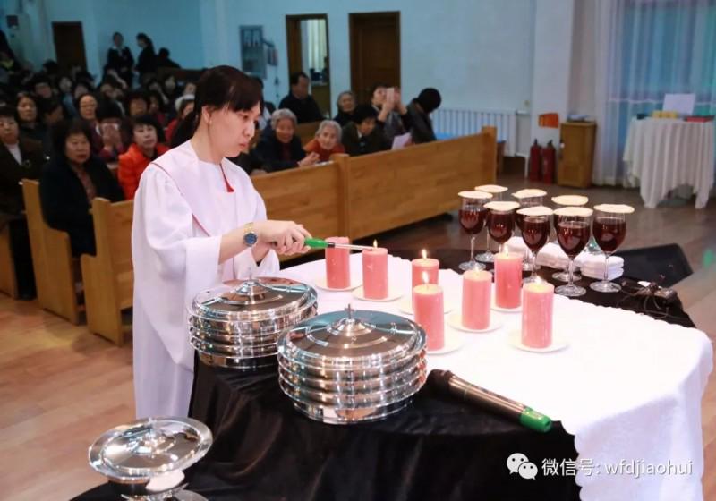 A pastoral worker lit the candles on the alter in Wafangdian Church, March 29, 2018.