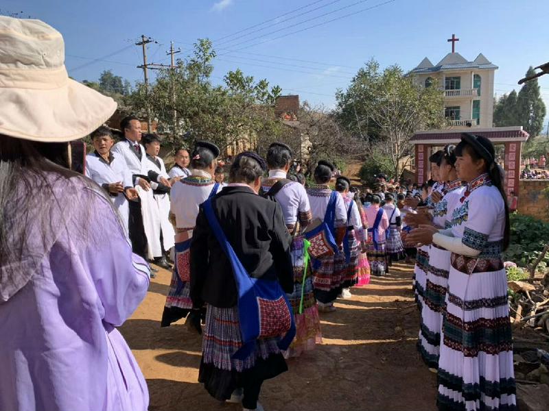 Miao believers walked to the church while other members stood in two lines to welcome them.