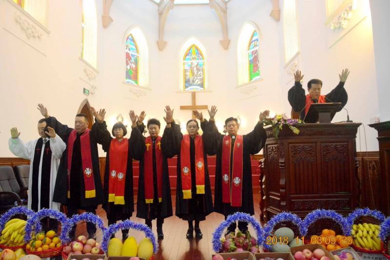 Pastors collectively pronounce a benediction over the church.