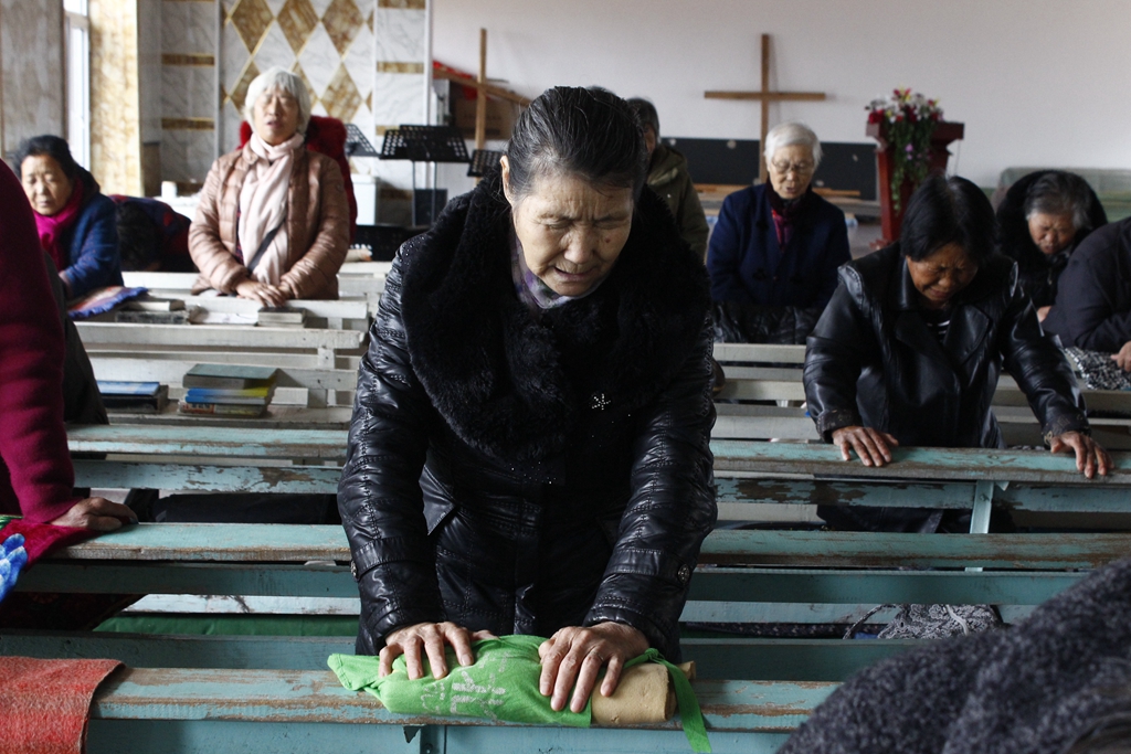 The prayer team prayed to God on their knees.