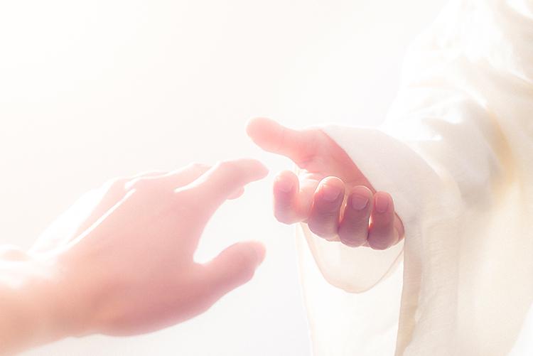 Reaching out to the hand of Jesus. 