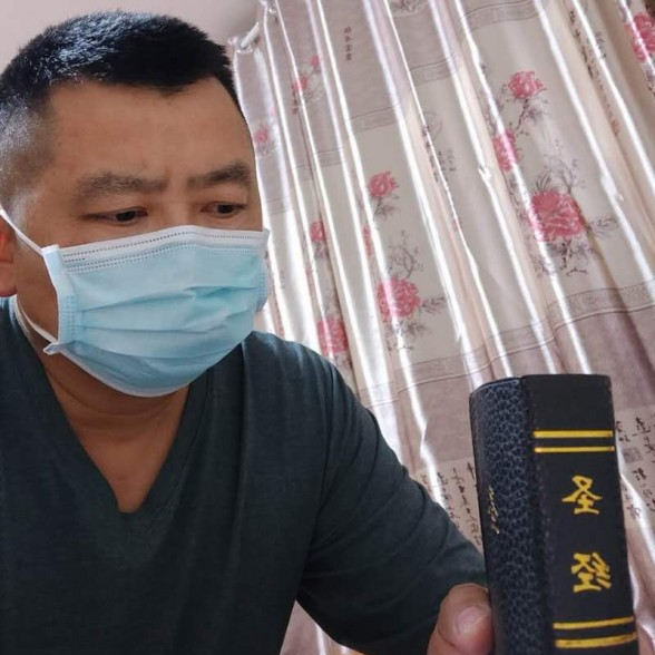 Brother Tian held the Bible he bought at the church where he walked into in early 2020.