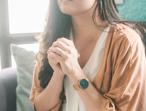 A woman prays to God. 