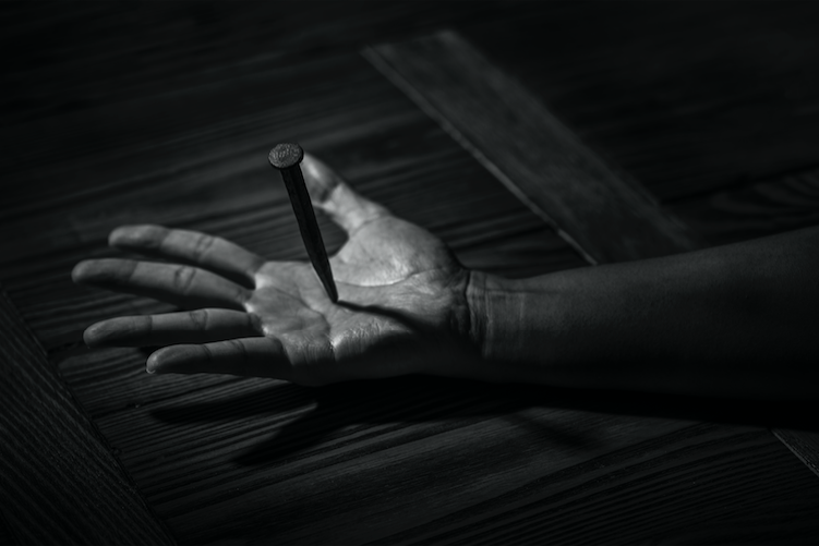 A palm pierced by a nail.