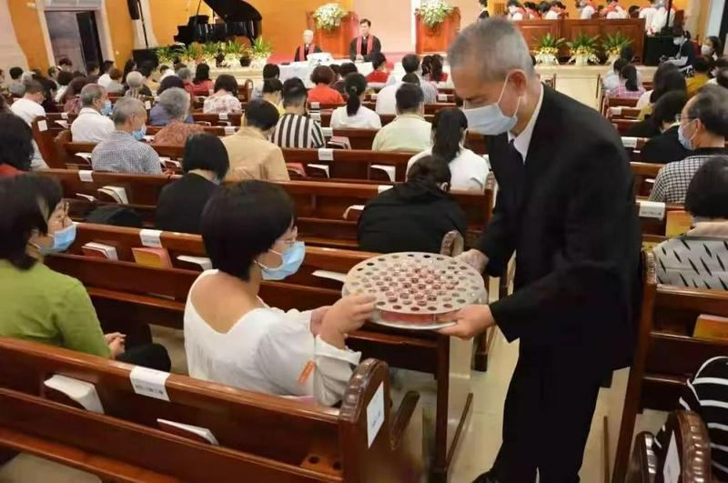 A believer of Zion Church, Guangzhou, Guangdong Province received the cup in an Easter Sunday service on April 4, 2021.